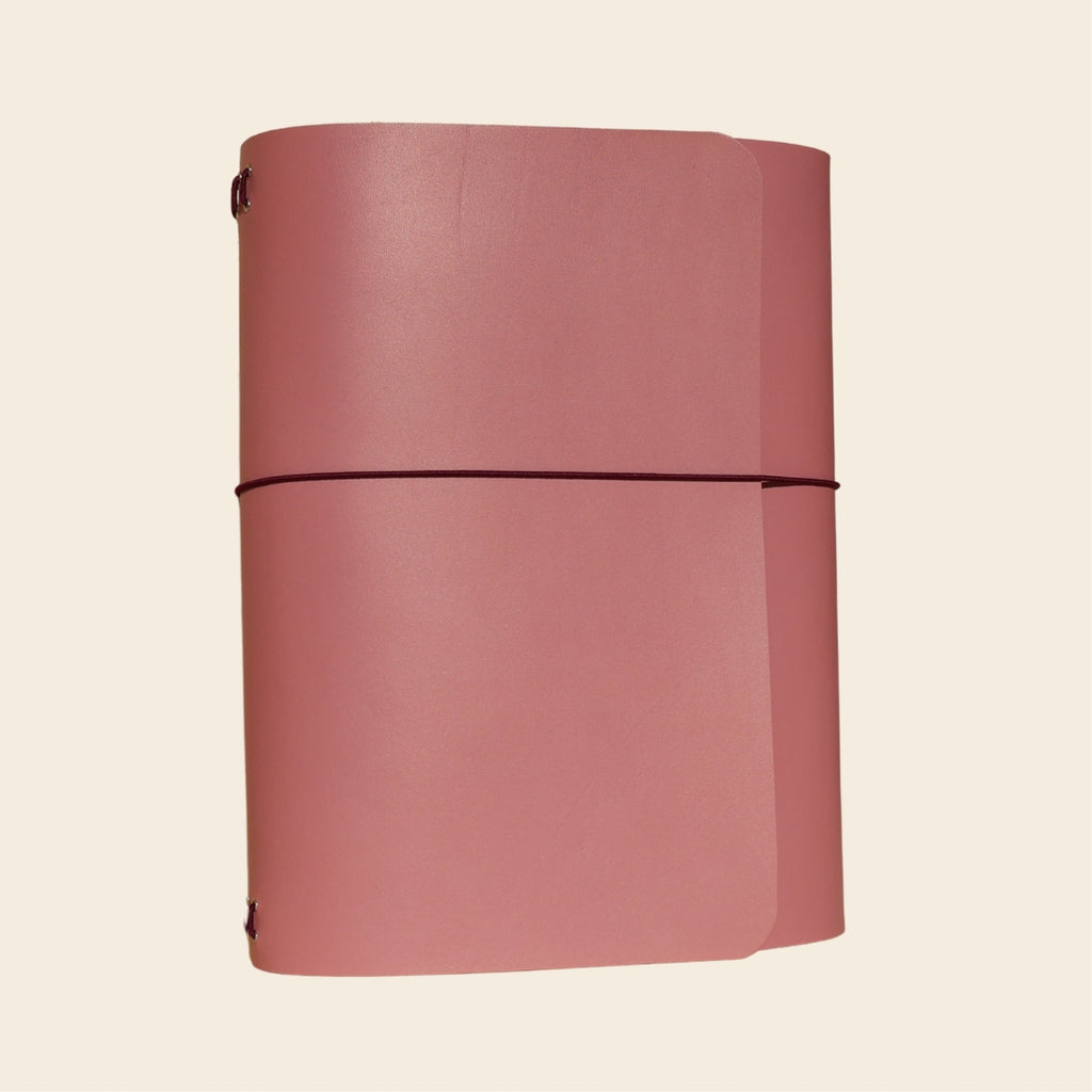 Pink journal on a beige background