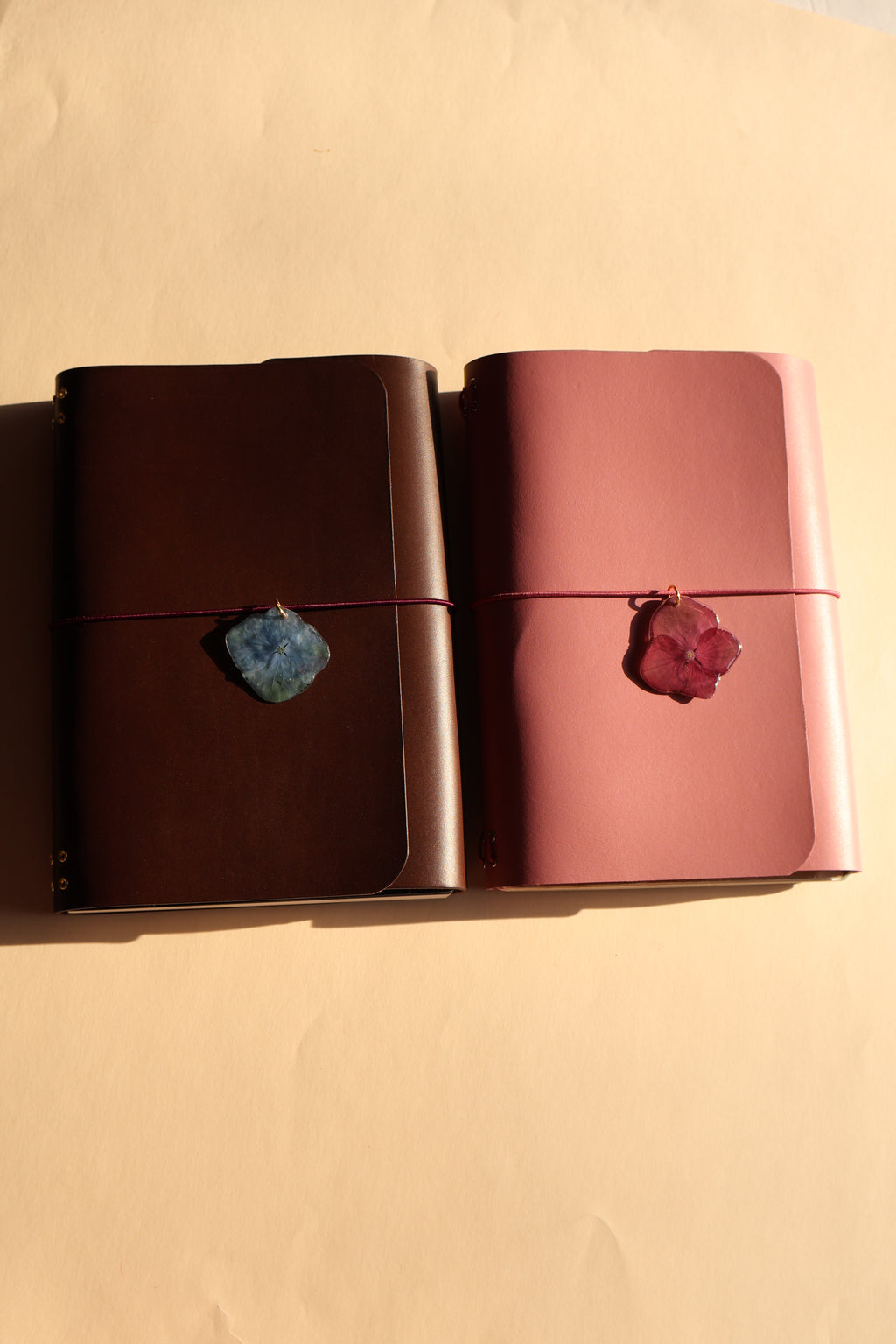 Two pink and brown with decorative stones on a beige background