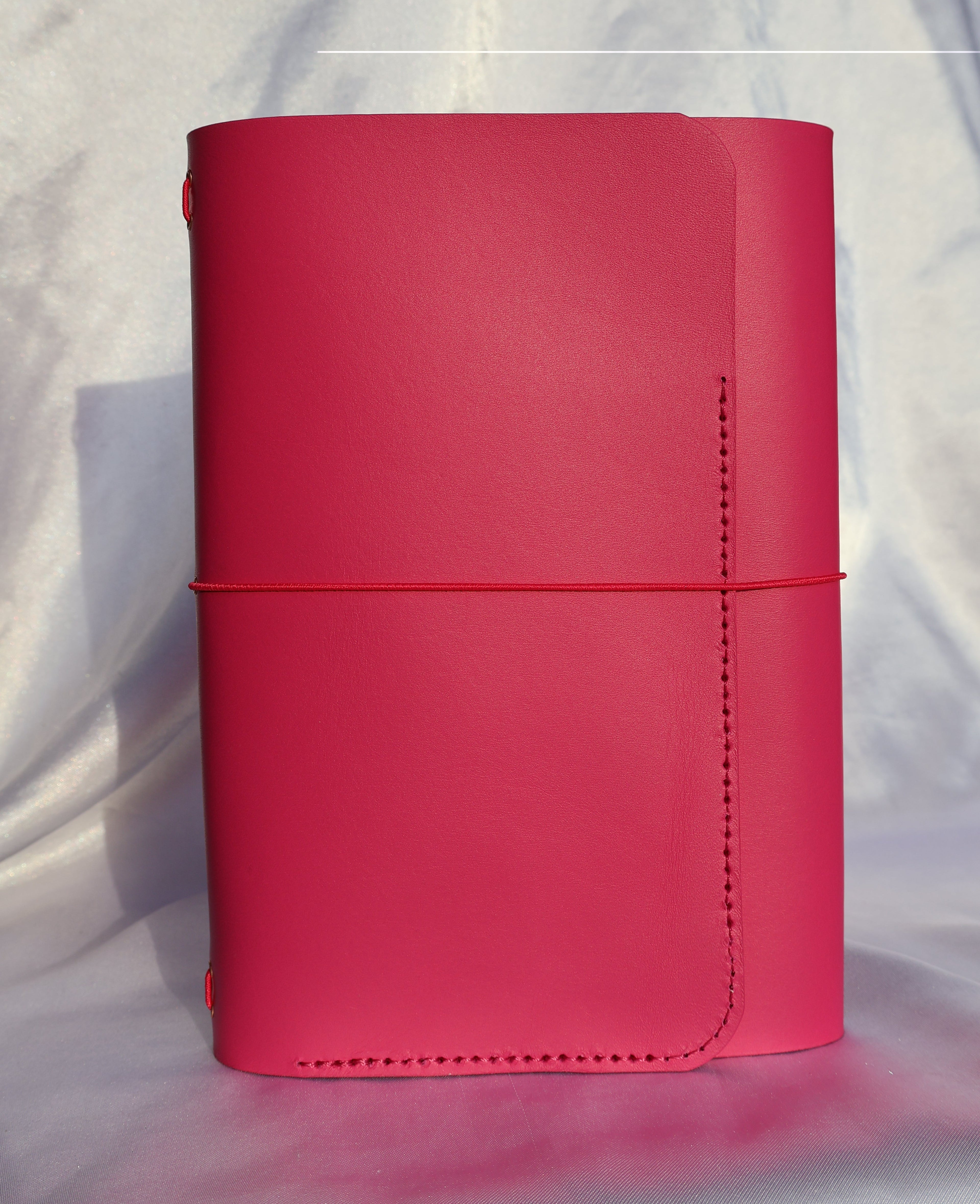 Red wallet on a white fabric background