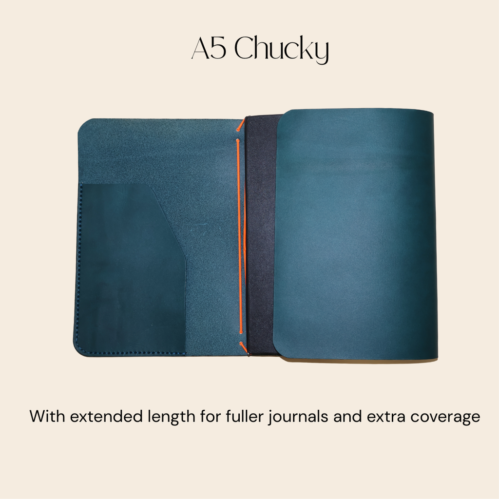Blue notebook cover with extended length feature on a beige background