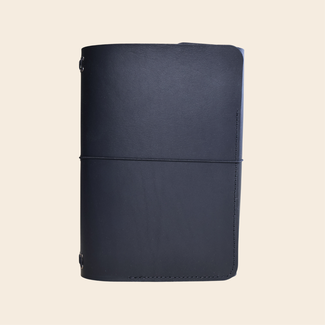 black leather notebook on a beige background